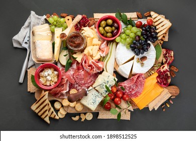 Appetizers Table. Cheese, Fuits And Meat Board On Dark  Background. Top View
