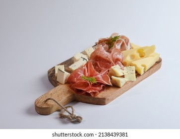 Appetizers table with different antipasti, charcuterie, snacks and cheese. Buffet party. Wooden cutting board isolated on white background, top view
 - Powered by Shutterstock