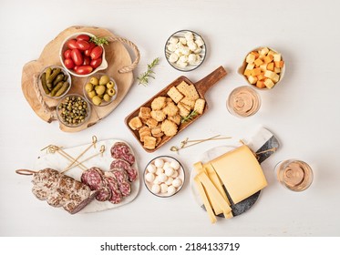 Appetizers table with different antipasti, charcuterie, snacks, cheese. Finger food for buffet party. Traditional french or italian entires. Top view - Powered by Shutterstock