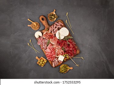 Appetizers Table With Differents Antipasti, Charcuterie, Snacks And Wine. Sausage, Ham, Tapas, Olives, Cheese And Crackers For Buffet Party. Top View, Flat Lay