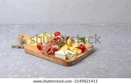 Appetizers table with differents antipasti, charcuterie, snacks and cheese. Buffet party. Top view, copy space, negative space