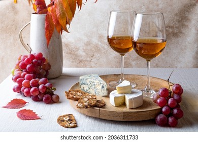 Appetizers Table With Wine Glasses. Fall Fruit Cheese Board. Tasty Cheese Starter With Grapes And Crackers.