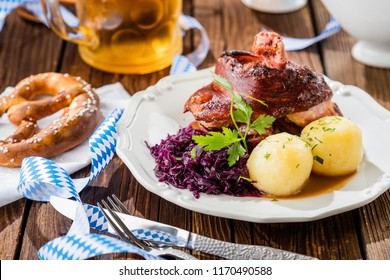 Appetizing Bavarian Roast Pork Dish With Dumplings And Pretzel