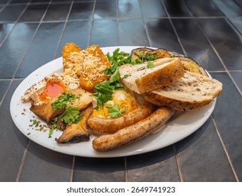 Appetizing breakfast spread with fried eggs juicy sausages crispy potatoes mushrooms fresh parsley and bread