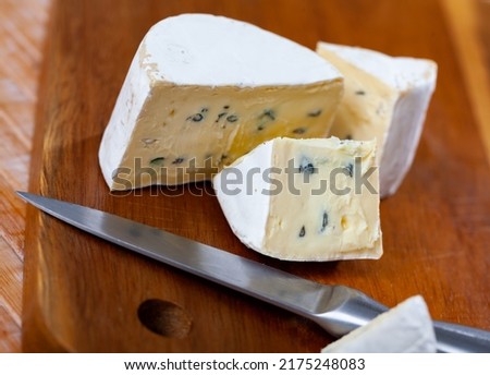 Appetizing cheese Bavaria blu, cut into pieces, with white and blue noble mold, famous for its low gluten and lactose content