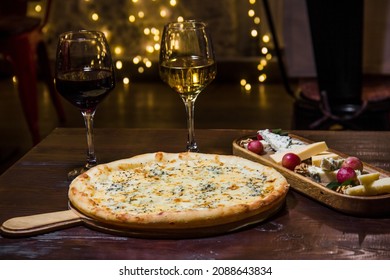 
Appetizing Cheese Pizza, Glass Of Wine And Cheese Board On A Wooden Table. Festive Mood. Pizzeria