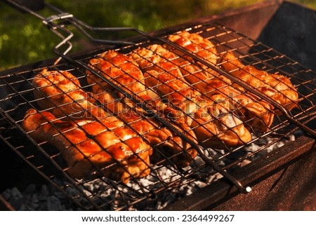 Appetizing chicken legs on the grill.B-B-Q. Stock fotó © 