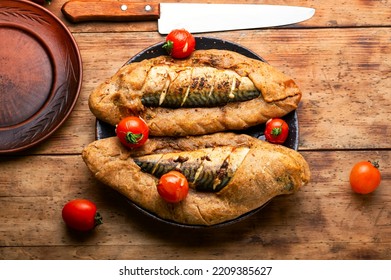 Appetizing food, mackerel baked in spicy dough. Seafood in dough - Shutterstock ID 2209385627