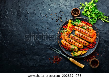 Appetizing grilled sausages with grilled vegetables. Sausages fried with pepper.