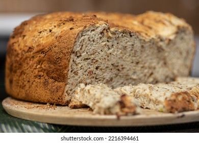 Appetizing Homemade Bread With A Golden Crust Lies On A Wooden Board