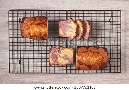 Appetizing homemade raspberry marble cake sliced on a cooling rack