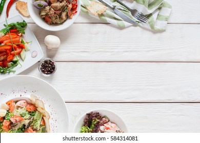 Appetizing Meat Side Dishes Frame Flat Lay. Top View On White Wooden Table With Warm Salads. Restaurant Menu, Buffet, Banquet, Party Concept