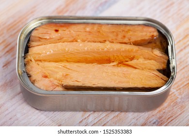 Appetizing Natural Frigate Mackerel Fillets In Open Tin Can On Wooden Table 

