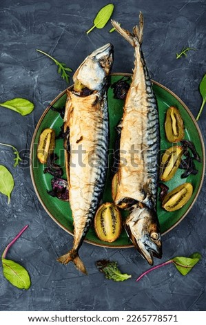 Appetizing prepared mackerel, scomber fish baked with kiwi pieces.