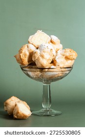 Appetizing profiteroles with custard . Eclairs, coffee, dessert.