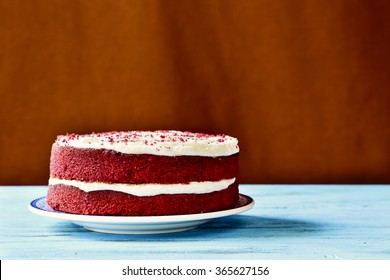 An Appetizing Red Velvet Cake On A Rustic Blue Wooden Table