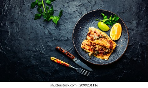 Appetizing roasted fish, fried pike perch in orange sauce.