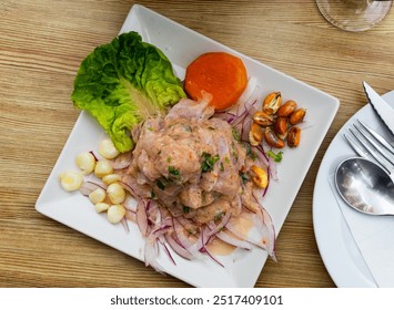 Appetizing seviche - typical Peruvian dish from fresh raw fish marinated in lime juice served with vegetables
