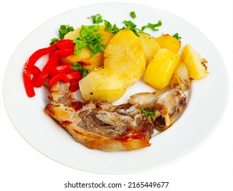 Appetizing Side Dish Of Baked Lamb Leg With Potatoes And Red Pepper, Decorated With Fresh Chopped Herbs. Isolated Over White Background