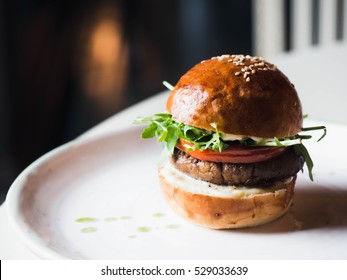 Appetizing Vegetarian Burger With Black Bean Patty And Glossy Buns On A White Plate, Horizontal