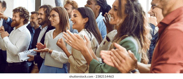 Applauding people. Happy satisfied audience joyfully applauding during business conference or seminar. Side view portrait of smiling men and women clapping their hands. Panoramic web banner. - Powered by Shutterstock