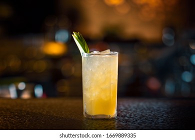 Apple based cocktail served in a long glass with ice