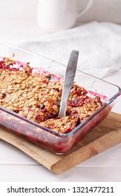 Apple And Berry Crumble, Topped With Oats In Glass Baking Dish On White Table. Crispy Fruit Pie, Healthy Summer Dessert. Close-up.