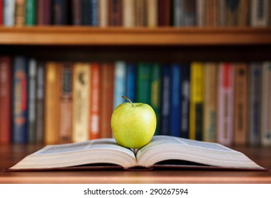 apple and book on background bookshelf - Shutterstock ID 290267594
