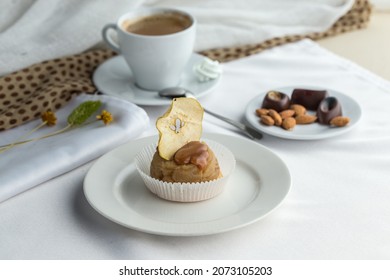 Apple Cake With Caramel Sauce Topping Served On Plate With Cup Of Coffee On The Table Side View