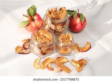 Apple chips in glass jars on sunny background,detox diet and weight loss concept,homemade dried apple slices on kitchen table,natural food for healthy lifestyle,advertisement for store, - Powered by Shutterstock