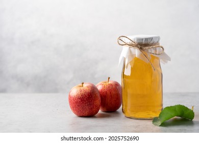 Apple Cider Bottle And Red Apples On Light Gray Background