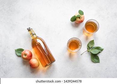 Apple cider drink or fermented fruit drink and organic apples on white, top view, copy space. Healthy eating and lifestyle concept.