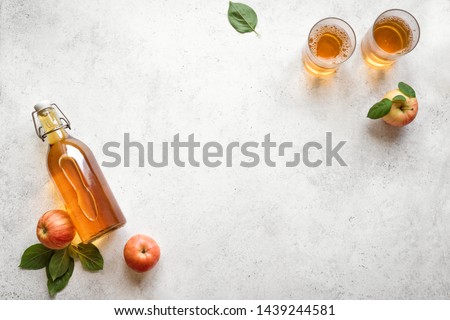 Apple cider drink or fermented fruit drink and organic apples on white, top view, copy space. Healthy eating and lifestyle concept.
