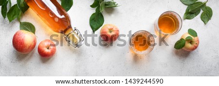 Apple cider drink or fermented fruit drink and organic apples on white, top view, banner. Healthy eating and lifestyle concept.