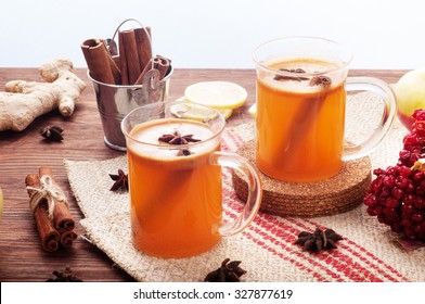 Apple cider in glass cups on a dark wooden background; cinnamon; star anise; the concept of home-made cider - Powered by Shutterstock