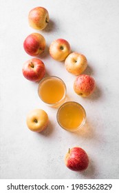 Apple cider or juice drink and apples on white background, top view, copy space. Garden organic red and yellow apples and fermented drink.