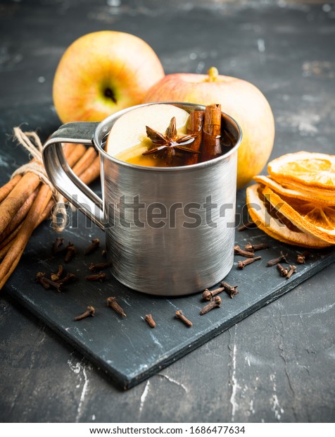 Apple cider in metal mug on the\
rustic background. Selective focus. Shallow depth of\
field.\

