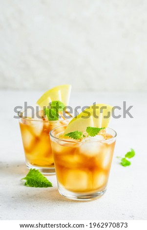 Apple cider summer drink, apple iced tea in glasses. Space for text.