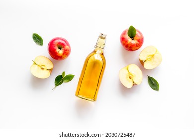 Apple Cider Vinegar In Glass Bottle With Fresh Red Apples