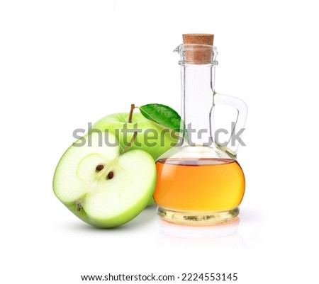 Apple cider vinegar in glass decanter bottle isolated on white background.