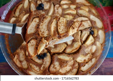 Apple, Cinnamon Cake. A Slice Has Been Lifted Up.