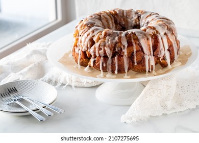 An Apple Cinnamon Pull Apart Coffee Cake Drizzled With Icing, Ready For Serving.