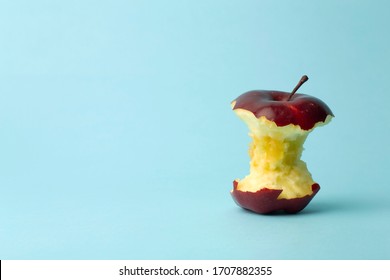 Apple core on a blue background. Food, fruit and vegetarian concept.