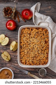 Apple Crumble. Homemade pie of fresh apples with caramel and cinnamon. Delicious autumn pastries. healthy dessert. Breakfast. Wooden background. Rustic style. Selective focus, top view  - Shutterstock ID 2213466055