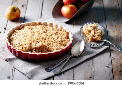 Apple Crumble On The Wooden Background With Apples .