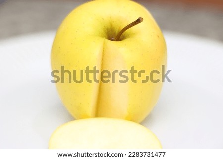 apple with a cut piece with selective focus. a´pple details. apple on white plate.