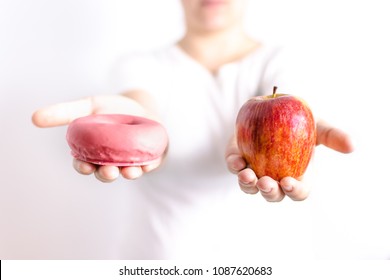 apple and donut in the hands - Shutterstock ID 1087620683