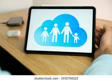 Apple Family Sharing Logo On The Screen Of IPad Tablet. March 2021, San Francisco, USA