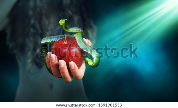 Apple fruit in a hand of a woman with a\
snake on top of it. Forbidden fruit\
concept.