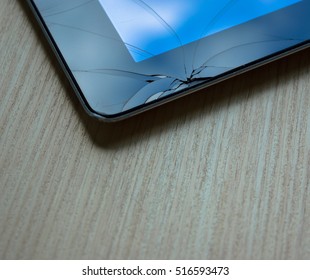 Apple IPAD Repair And Maintenance Or Computer Tablet With Broken Touch Screen On Wooden Desk